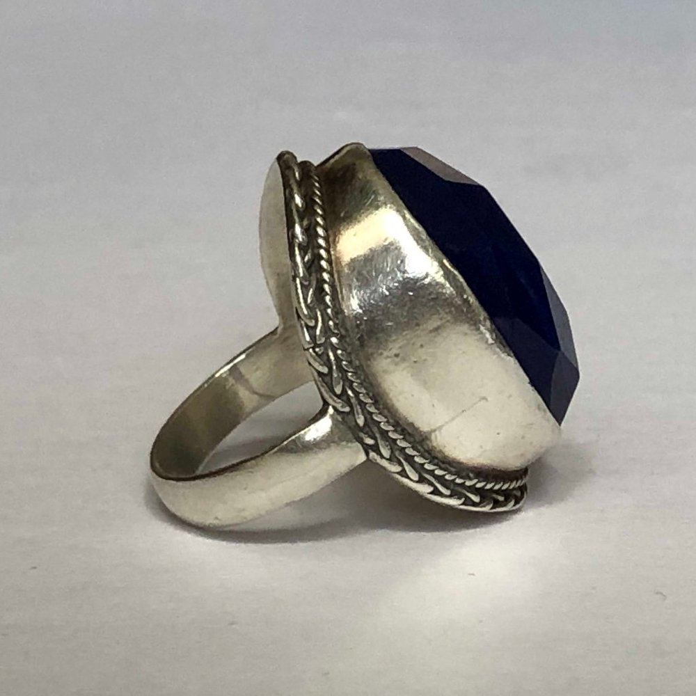Silver statement ring with a blue sapphire stone